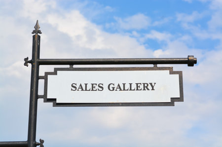 View of sales gallery sign against the blue skyの写真素材