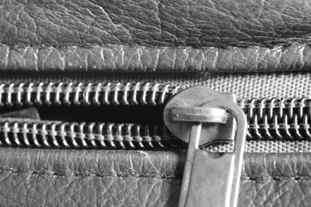 The intricate zipper detail comes to life in a captivating close-up, revealing its fine craftsmanship and adding a touch of elegance to the overall design.の写真素材