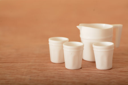Tea cup toy set on a wooden table. Kids tea coffee serving setの写真素材