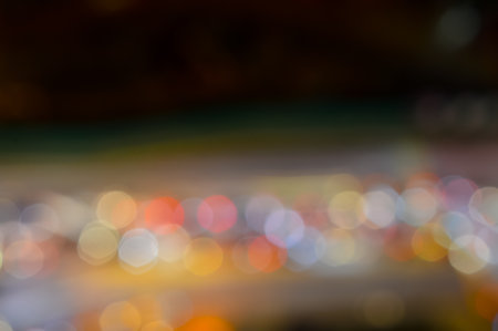 Bokeh lights shimmer amidst the cityscape at night, creating a mesmerizing tapestry of urban beauty...