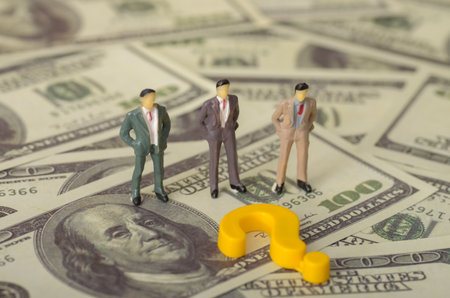 The pursuit of money often creates a complex interplay between individuals, particularly businessmen, marked by uncertainty and decision-making.の写真素材