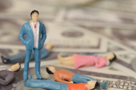 The businessman, elevated above his fallen peers on a pile of banknotes, illustrates the stark difference between those who navigate financial challenges wisely and those who do not.の写真素材