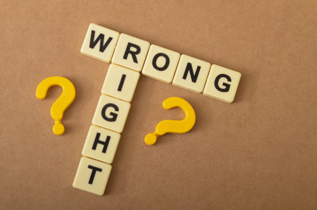the contrast between right and wrong, with the letters forming the words "RIGHT" and "WRONG" arranged in a conflicting manner.の写真素材