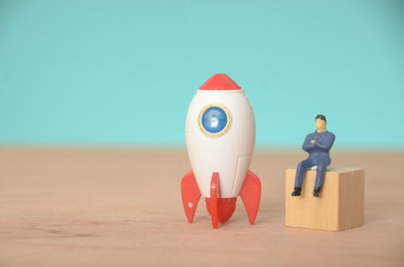 Amidst the excitement of the rocket launch, the businessman remained seated, strategizing the next big project that would catapult his company to new heights.の写真素材