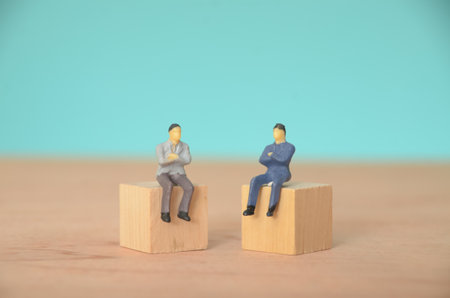 Sitting together in a conference room, the businessman and his partner exchanged ideas to align their goals and achieve their target.の写真素材