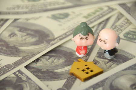 the elderly couple, the house, and the money highlights the importance of home equity in retirement planning, providing a potential source of income or financial security.の写真素材