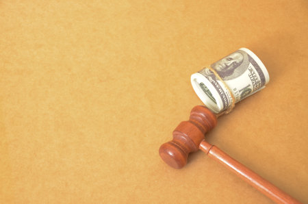 The image might suggest that money plays a significant role in the legal system, such as in court fees, legal representation, or financial settlements.の写真素材