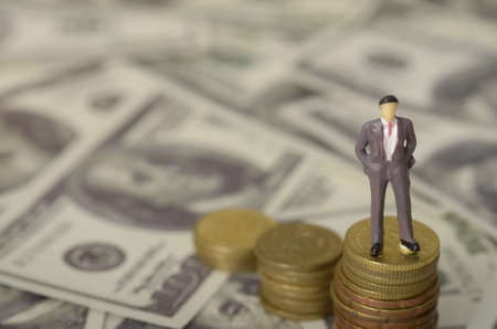 The image can be interpreted as a metaphor for the journey towards financial success, with the figure representing the individual and the coins symbolizing the accumulated wealth.の写真素材