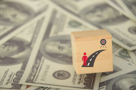 Achieving financial goals often involves making sacrifices and overcoming challenges.の写真素材