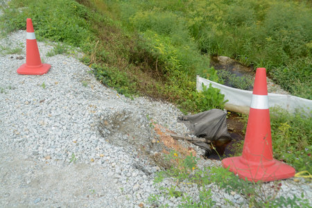 The image showcases the potential dangers of erosion and the importance of road maintenance.