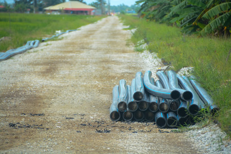 The image suggests that the pipes are being prepared for a construction or infrastructure project in the area.の写真素材