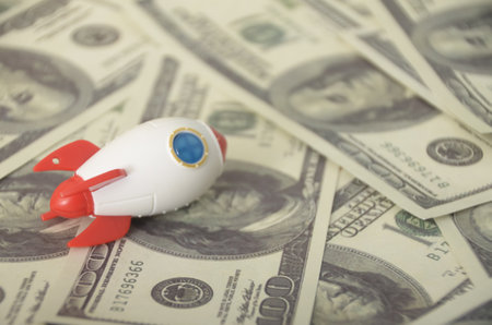 The combination of a rocket and money could symbolize the concept of investment, innovation, or...