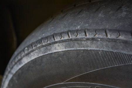 The tread on the tire is significantly worn down, with little to no tread depth remaining.