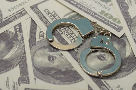 Handcuffs and Gun: A Symbol of Conflict and Danger in High-Stakes Situationsの写真素材