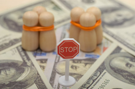 The stop sign serves as a warning, emphasizing the need to stop human trafficking and protect vulnerable individuals.の写真素材