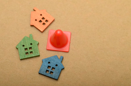 The image of a traffic cone and several houses symbolizes the concept of potential disruptions or...