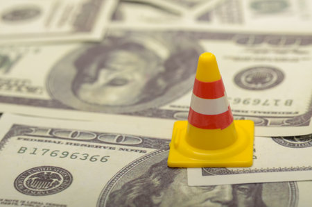 Safety Cone with USD Money Background: Concept of Financial Caution and Economic Awareness
