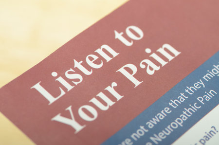 The image focuses on the phrase Listen to Your Pain printed in bold, white text on a red background.