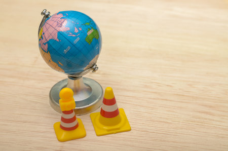 Safety Cones and World Globe Challenge in Global Logistics and Safety Awarenessの写真素材