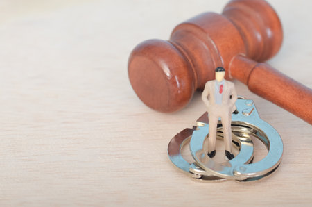 The image creates a powerful visual metaphor for the consequences of breaking the law and facing legal repercussions.の写真素材