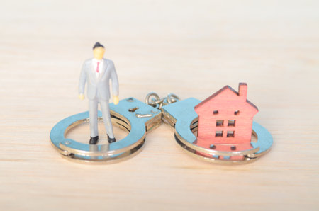 Financial Hardship and Legal Consequences: A Visual Metaphor for Housing Instabilityの写真素材