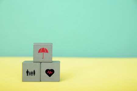 Building Safety: Wooden Blocks Depicting Insurance and Protection Conceptsの写真素材