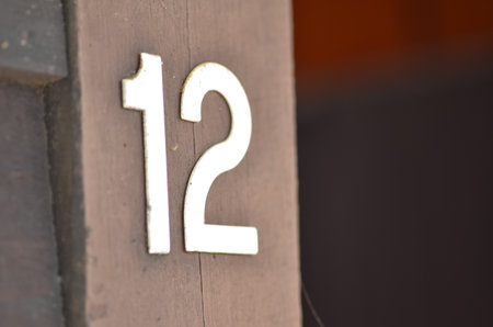 Aged Wooden Surface with Bold Number 12 â Vintage Address Signの写真素材