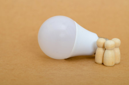 Symbol of Knowledge: Light Bulb Illuminating a Groupâs Understandingの写真素材