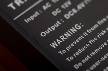 Close-Up of a Warning Label on an Electronic Device Emphasizing Safety Precautionsの写真素材
