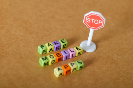 Fake Mobile Apps Warning â Colorful Letter Beads Highlight Digital Security Risksの写真素材