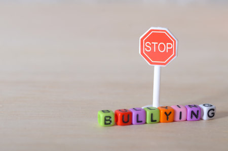 Bullying Awareness Symbolized with Playful Blocks and a Stop Signの写真素材