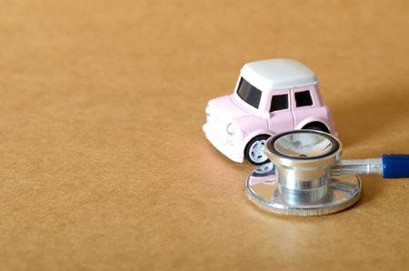 Toy Car and Stethoscope: Symbolizing Vehicle Health and Diagnosisの写真素材