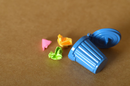 Colorful Chaos: Mini Trash Bin with Bright Paper Wasteの写真素材