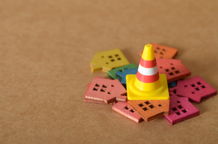 Residential Construction Warning with Wooden Houses and Traffic Cone