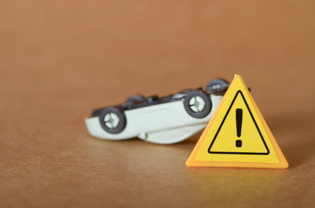 Overturned Toy Car with Traffic Light in Miniature Accident Sceneの写真素材