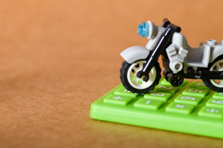 Close-Up of Bike Tire Pressing Calculator â€“ Budgeting for Motorbike Expenses