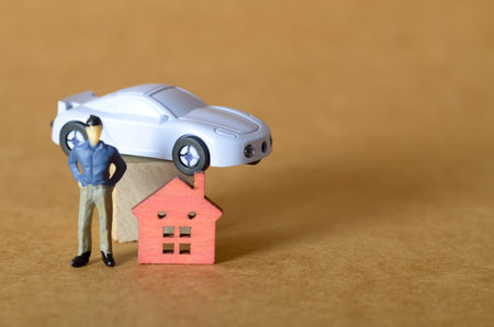Miniature Person with House and Car â Concept of Personal Finance and Asset Managementの写真素材