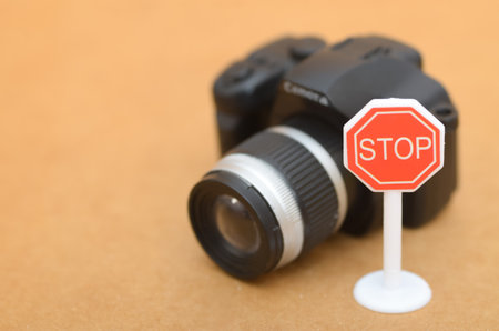 A Camera Facing a Stop Sign as a Metaphor for Ethical Photography Limitsの写真素材