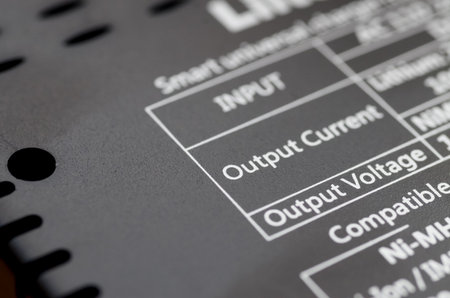 The table on the label provides information about the device's "Output Current" and "Output Voltage."の写真素材