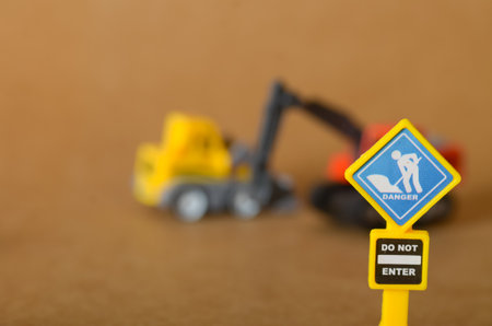 Danger: Do Not Enter sign with a digging worker icon at an active construction site.の写真素材