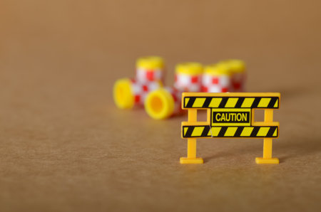 Prominent 'CAUTION' barrier with a blurred background indicating a potential hazard zone.の写真素材