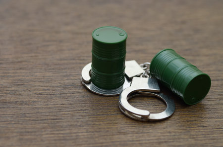 Environmental Crime: Hazardous Waste Barrel in Handcuffs Symbolizing Pollution and Legal Action.