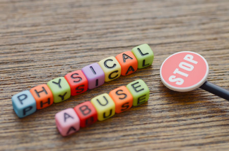 "Physical Abuse" juxtaposed with a stop sign highlights the hidden and often unseen reality of domestic violence and cruelty.の写真素材