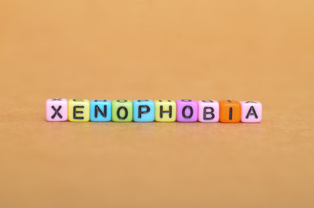 toy blocks spell out "Xenophobia" to raise awareness about intolerance. A direct visual message about prejudice, fear of foreigners, and discriminationの写真素材