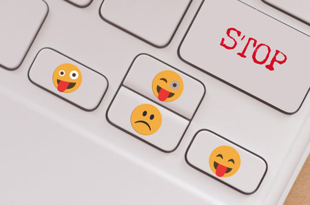 a keyboard with emotional stickers and a clear STOP key visualizes the concept of taking action...