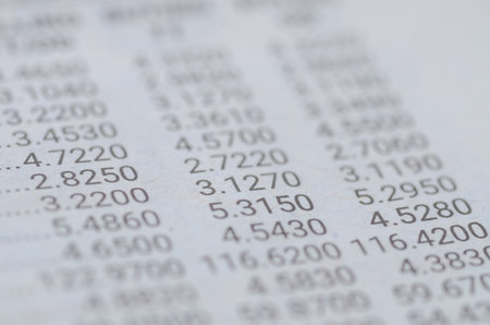 A close-up, in-focus shot of a financial document with columns of precise numerical data,...