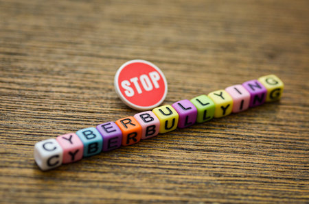 The word CYBERBULLYING is paired with a bold STOP sign, creating a powerful and direct visual...