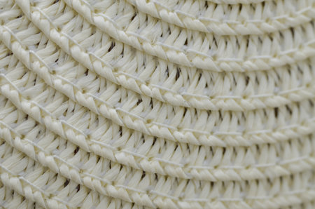 a woven wicker surface captures the detailed, interlaced texture of natural straw, evoking feelings...