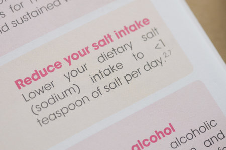 A document with the headline Reduce your salt intake in sharp focus, providing clear nutritional...