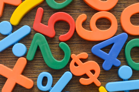 A close-up of scattered numbers and a dollar sign, creating a dynamic background for topics on finance, education, and childhood learning.の写真素材